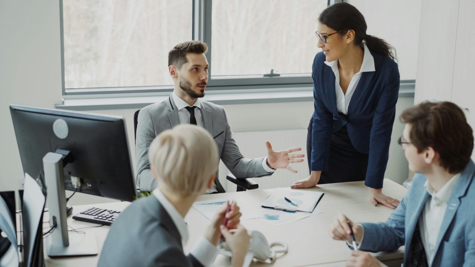 Business professionals discussing strategy and planning in a modern office
